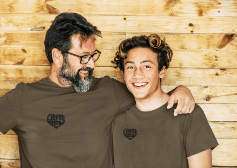 t-shirt-mockup-featuring-a-bearded-man-posing-with-his-son-against-a-wooden-wall-m6548-r-el2-min